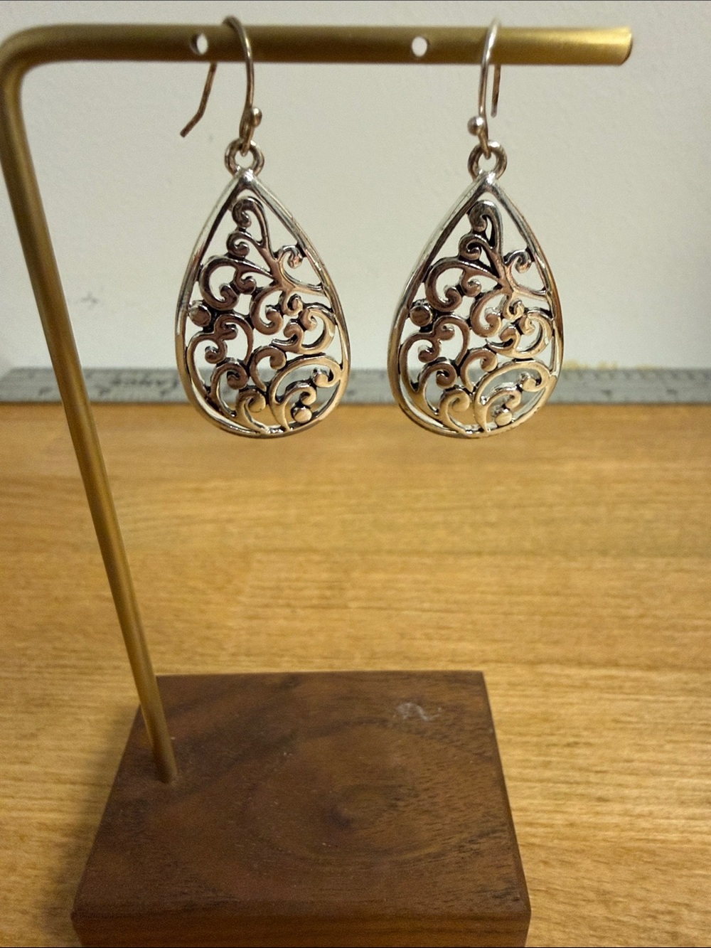 Silver tone teardrop dangle earrings with filigree accents brocade